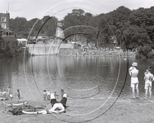 Hampstead Heath and Lake whilst in the background is a fun fair in North West London c1930s